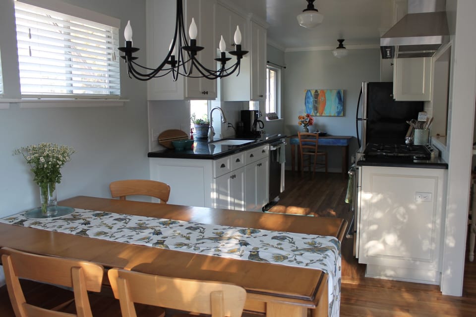 Brand-new kitchen with stainless steel appliances opens up to dining area