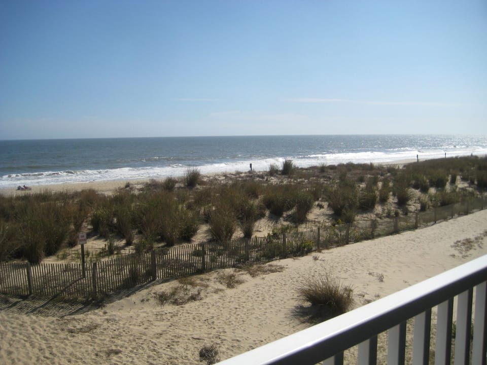 View of the beach from master bedroom upper level deck