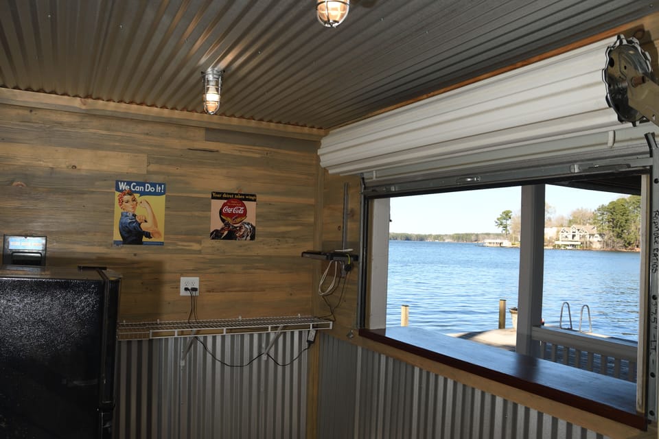 Boathouse with RollUp Window and Bar Stools, plus a refrigerator