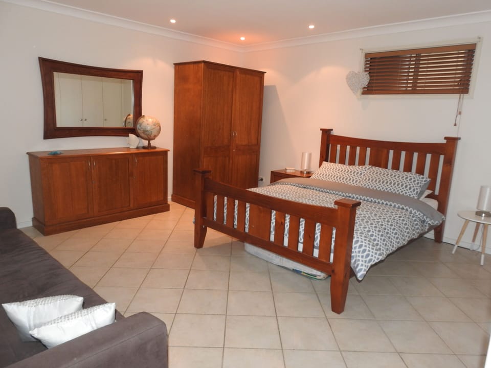 Separate large bedroom with Queen bed and sofa lounge