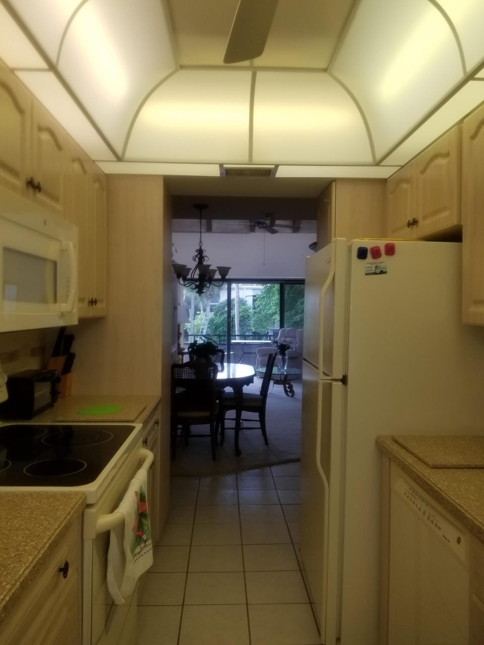 Full size refrigerator with ice maker, electric stove, oven and microwave.