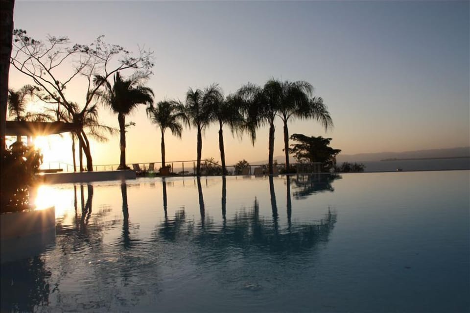 Sitting at the edge of the infinity pool at sunset overlooking Banderas Bay