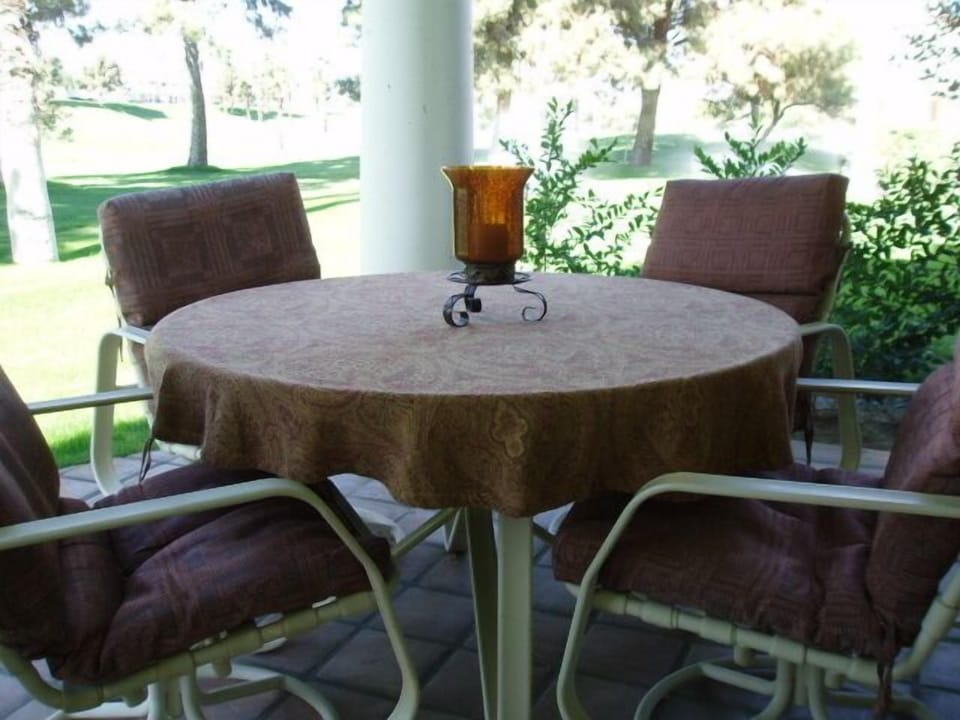 Back patio has a table and seating for four people.