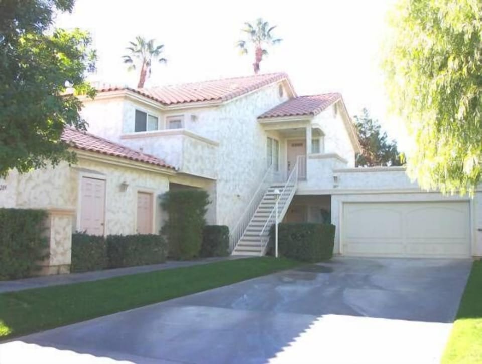 Front of condo (downstairs unit).  Large driveway and garage.