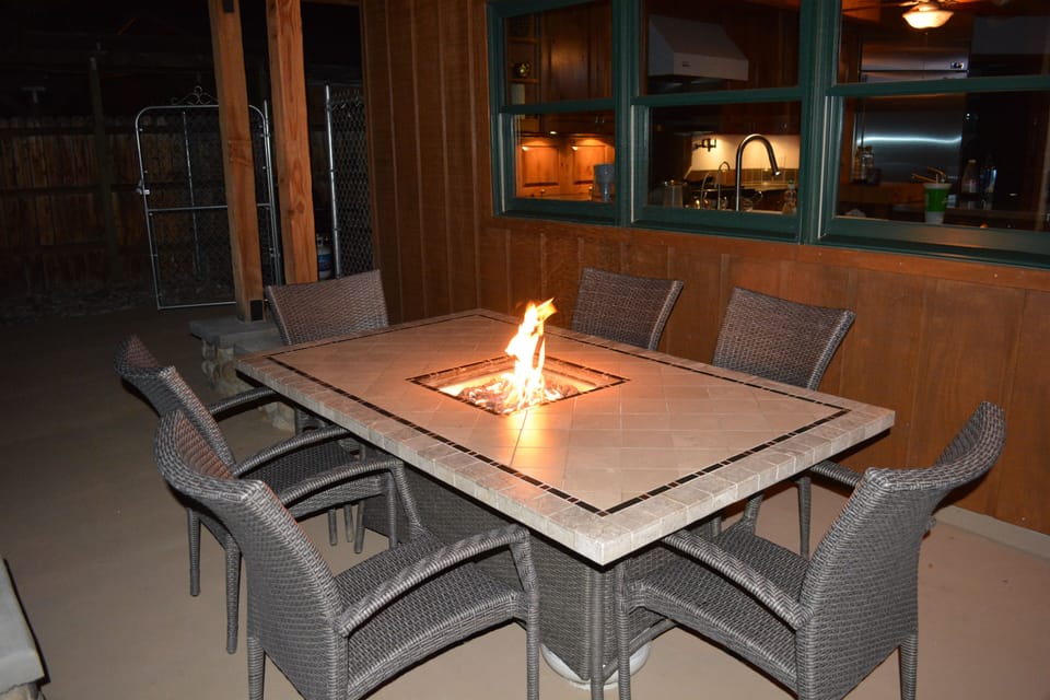 Outdoor dining table with fire pit