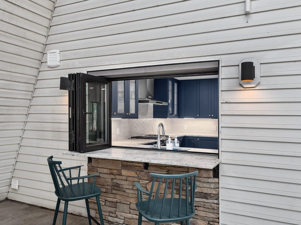 Pass-through kitchen window with counter seating on the upper deck.