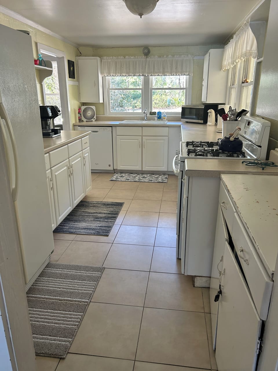 Original main kitchen, on front of home with gas oven, d/w, fridge