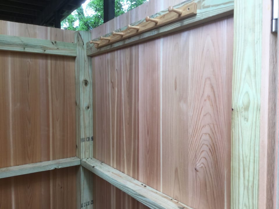 hooks for you to hang cloths and belongings in the outdoor shower