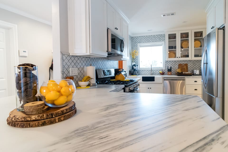 Gourmet kitchen, marble counter/backsplashes, large farm sink, and more!