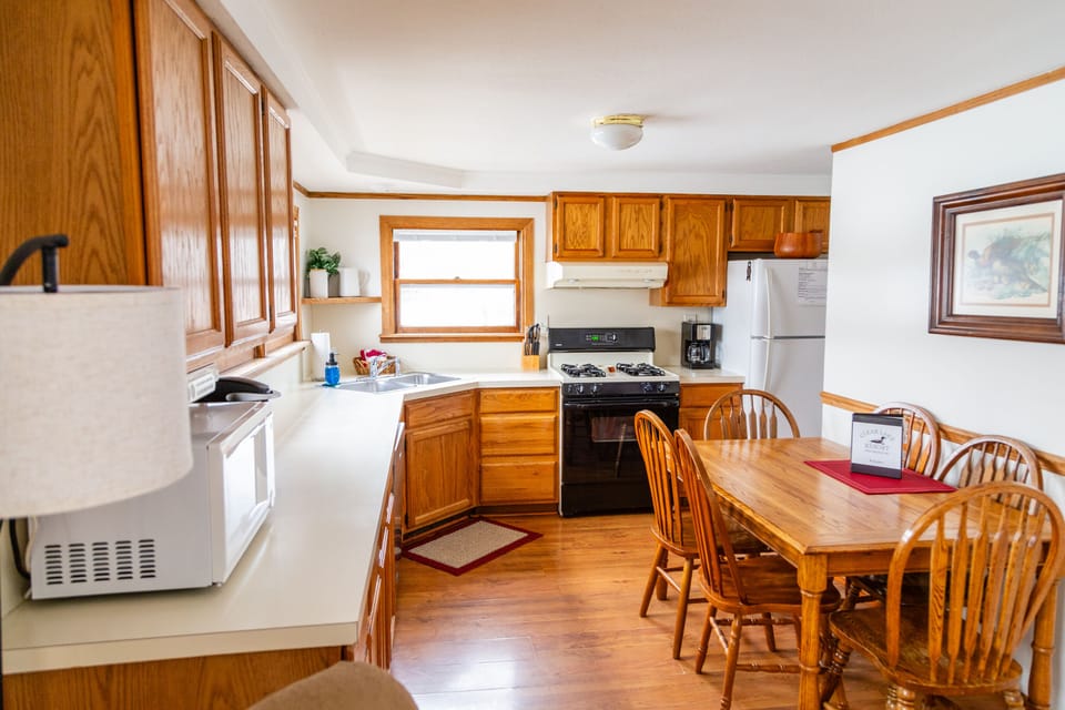 Stocked kitchen with dishes, pot and pans  and kitchen utensils