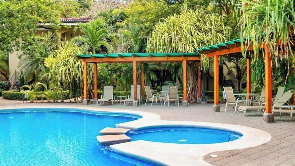 Lush gardens surrounding pool and shallow children's pool.