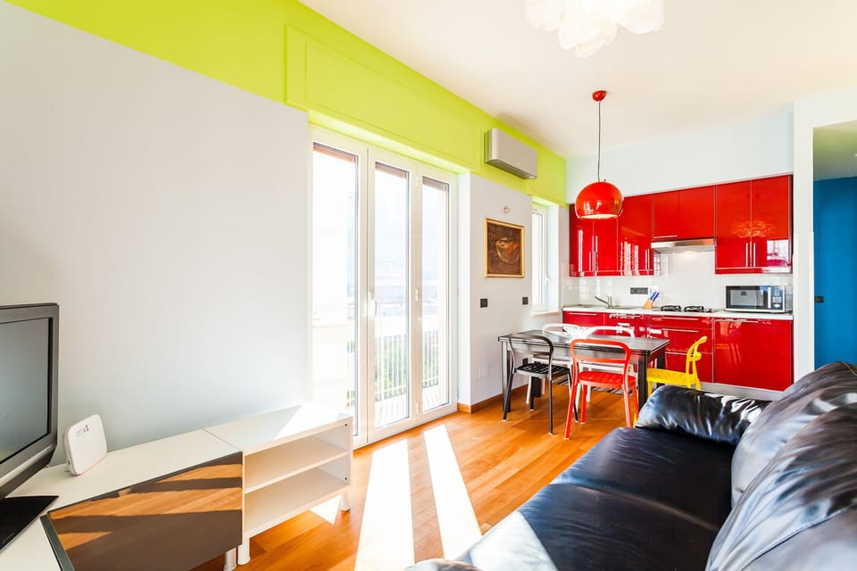 Living room, dining table, sofa bed, TV, balcony overlooking on Via degli Aranci