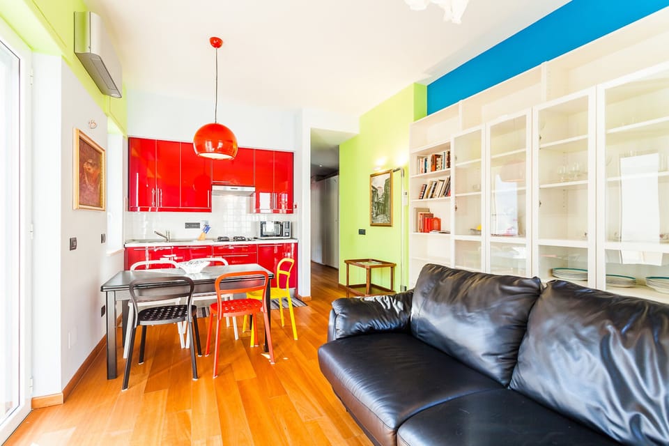 Living room, dining table, sofa bed, balcony overlooking on Via degli Aranci