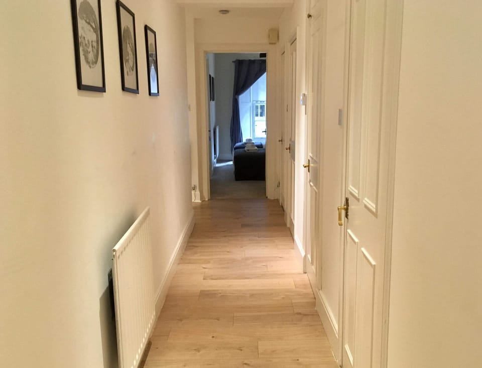 Hall leads to twin bedroom, toilet, showroom, living area and door downstairs