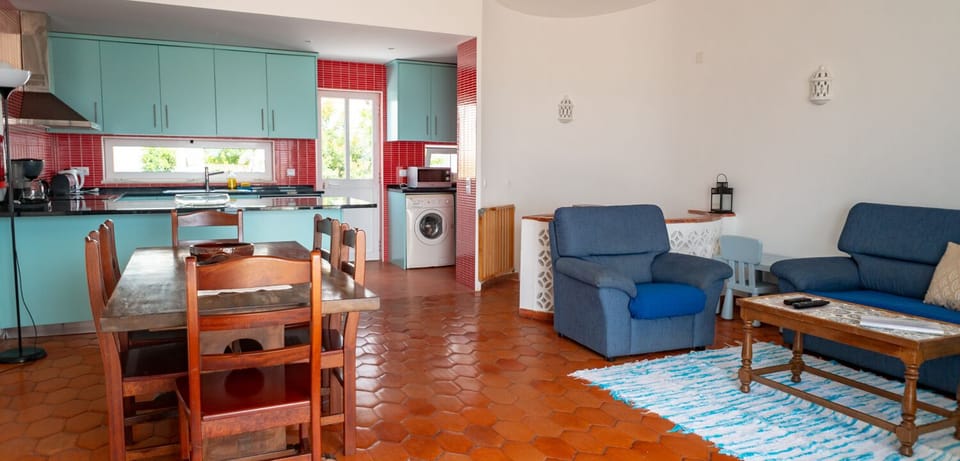 Charming living room and new kitchen with door to a front veranda with BBQ