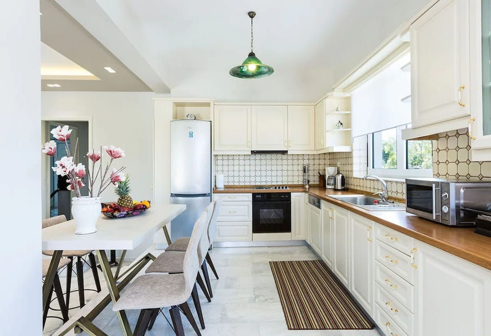 Fully equipped kitchen area with dining area on the ground floor