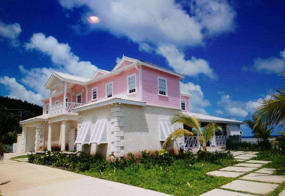 View of the house with entrance and garage visible also the wrap around veranda