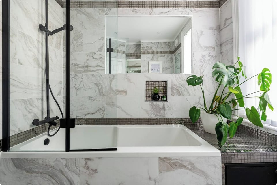 Shower, bath tub, mirrors and window for light and airflow