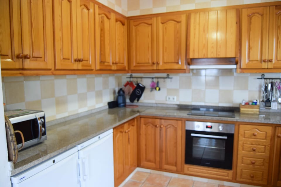 kitchen with dishwasher and see to the pool-SA PUNTA COSTA BRAVA