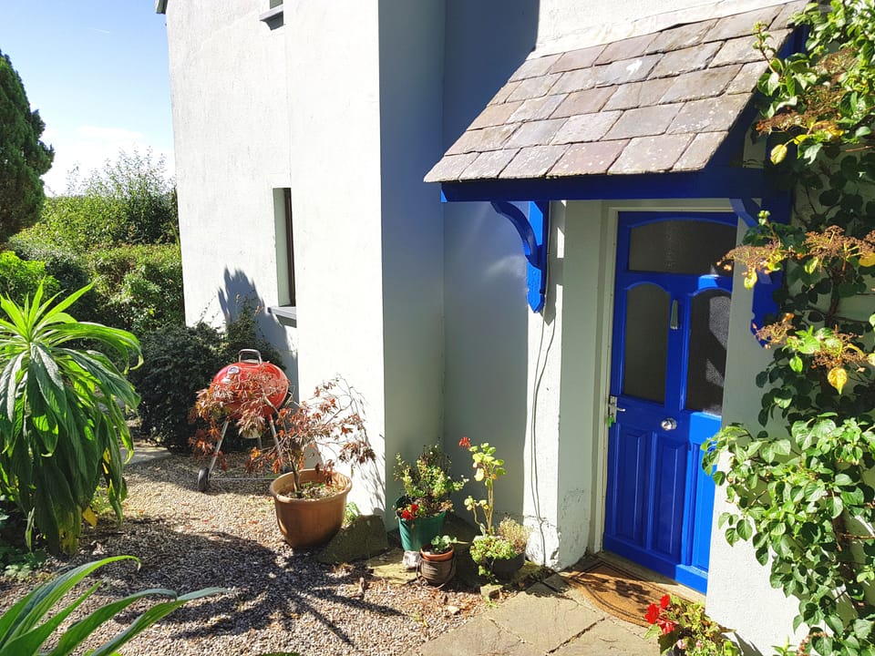 The attractive front door to Granary Cottage with BBQ nearby