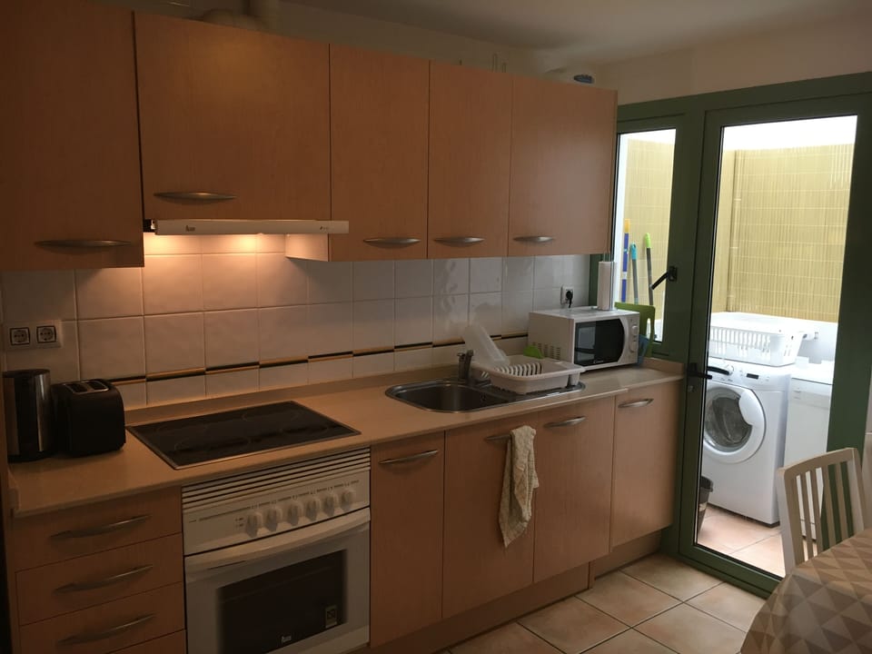 Kitchen with adjoining utility area.