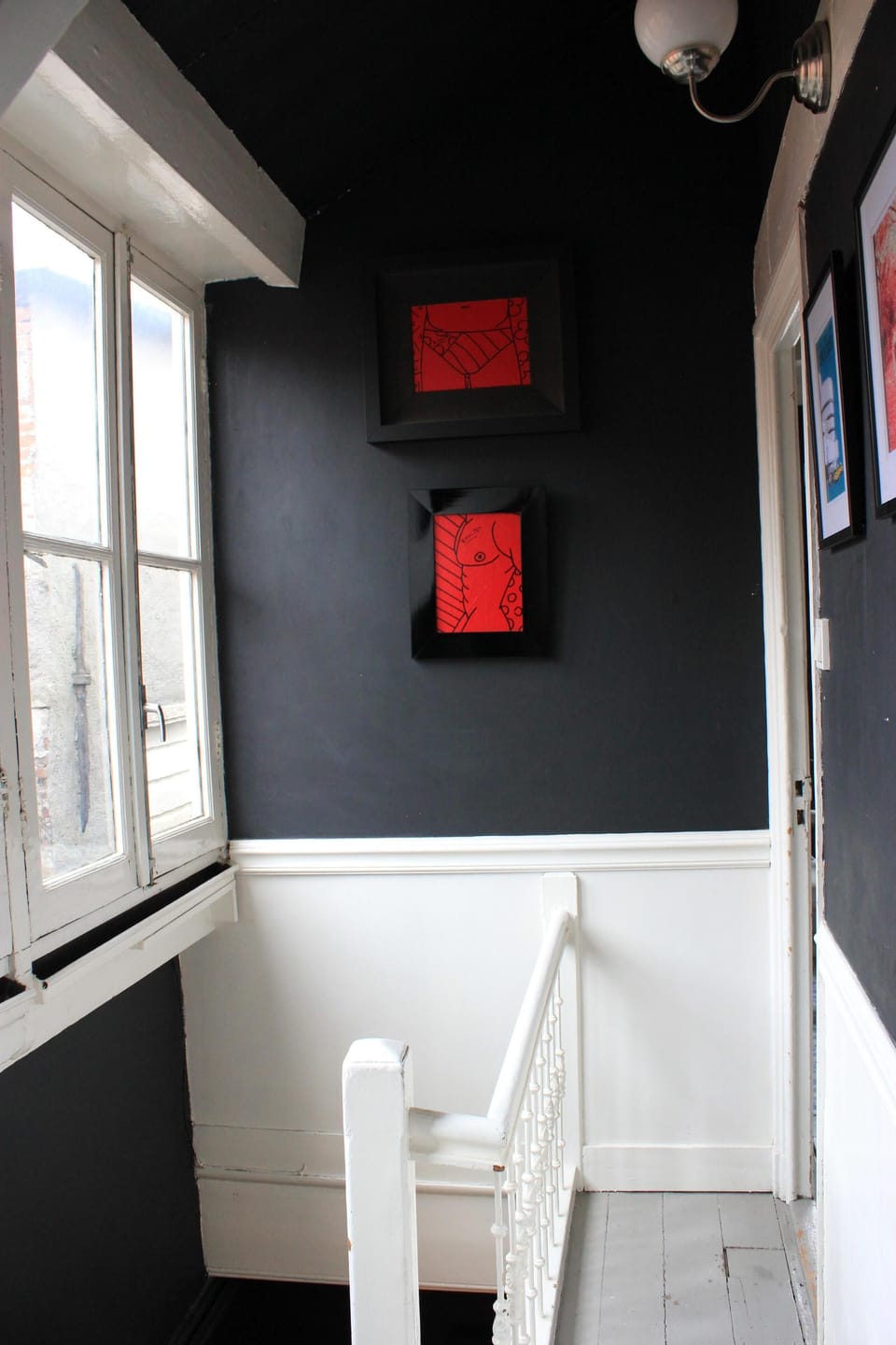 The upstairs staircase with art