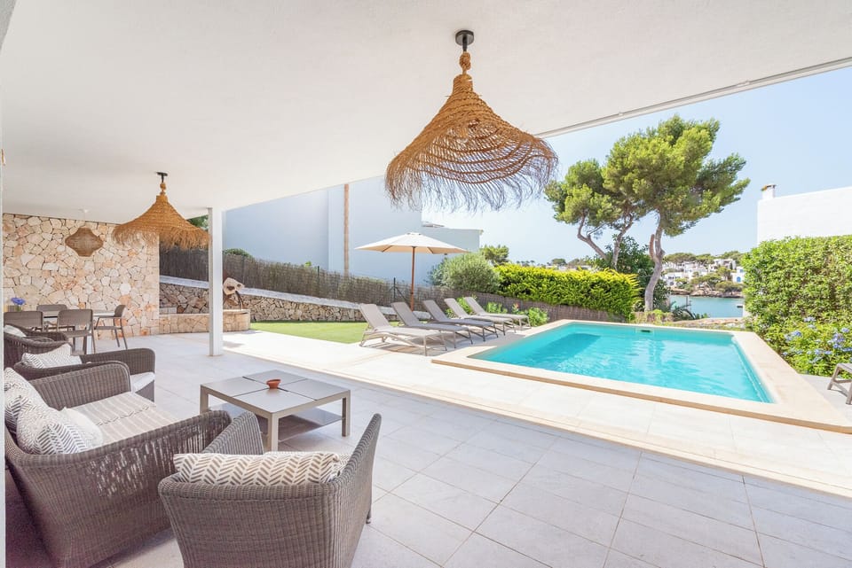 Ground floor terrace overlooking swimming pool and marina