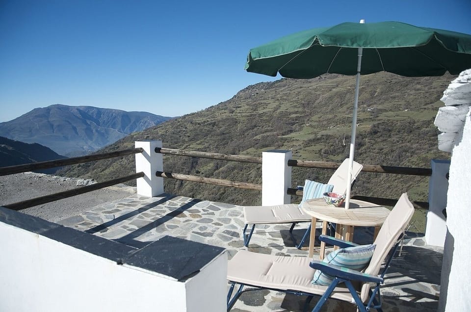 Terrace with table, chairs and parasol