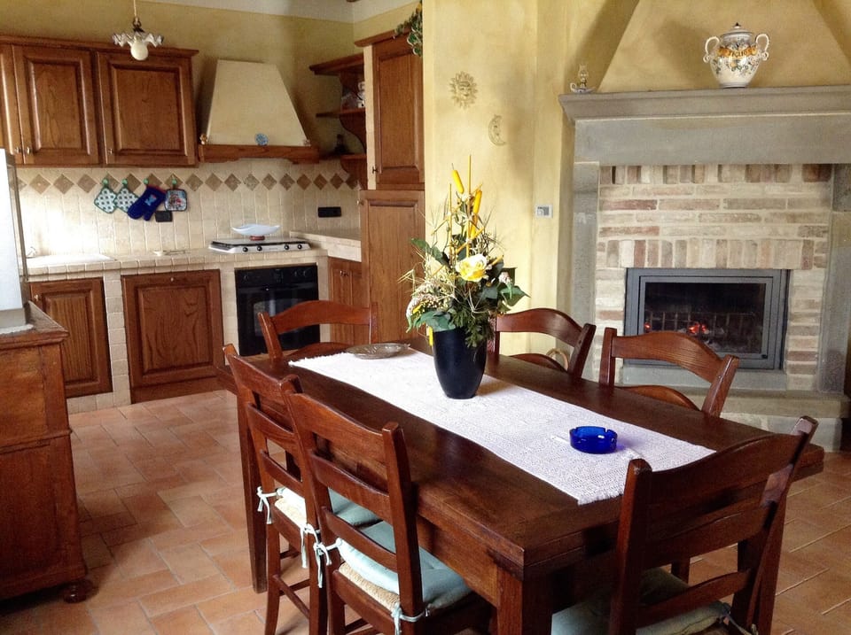 Kitchen with table for 8 and fireplace