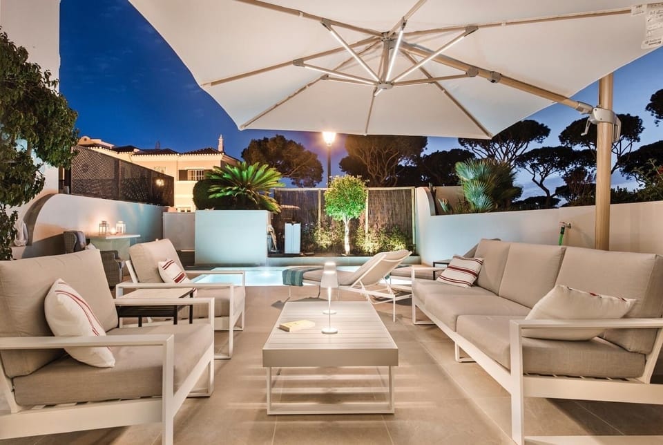 Terrace at night with the pool lights on 