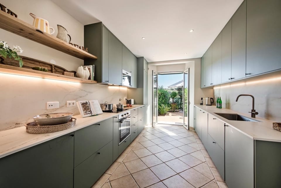 Kitchen with access to living area and garden to the back 