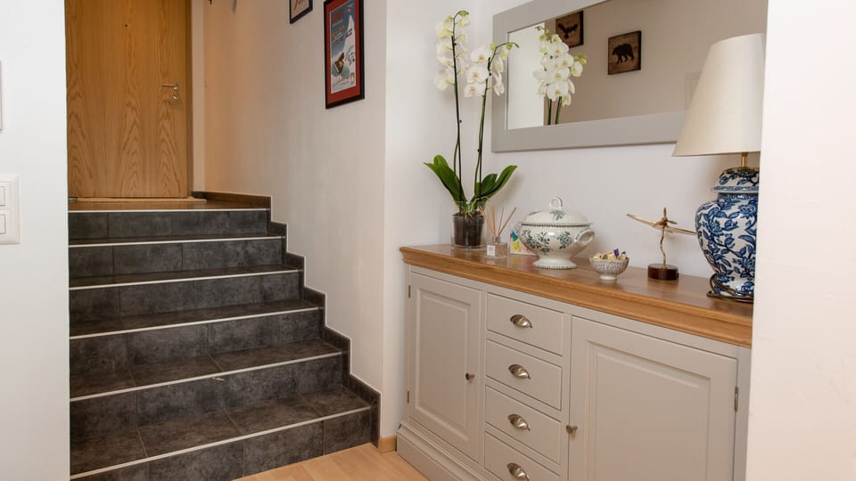 Stairs down in to the apartment from the front door create the feeling of space