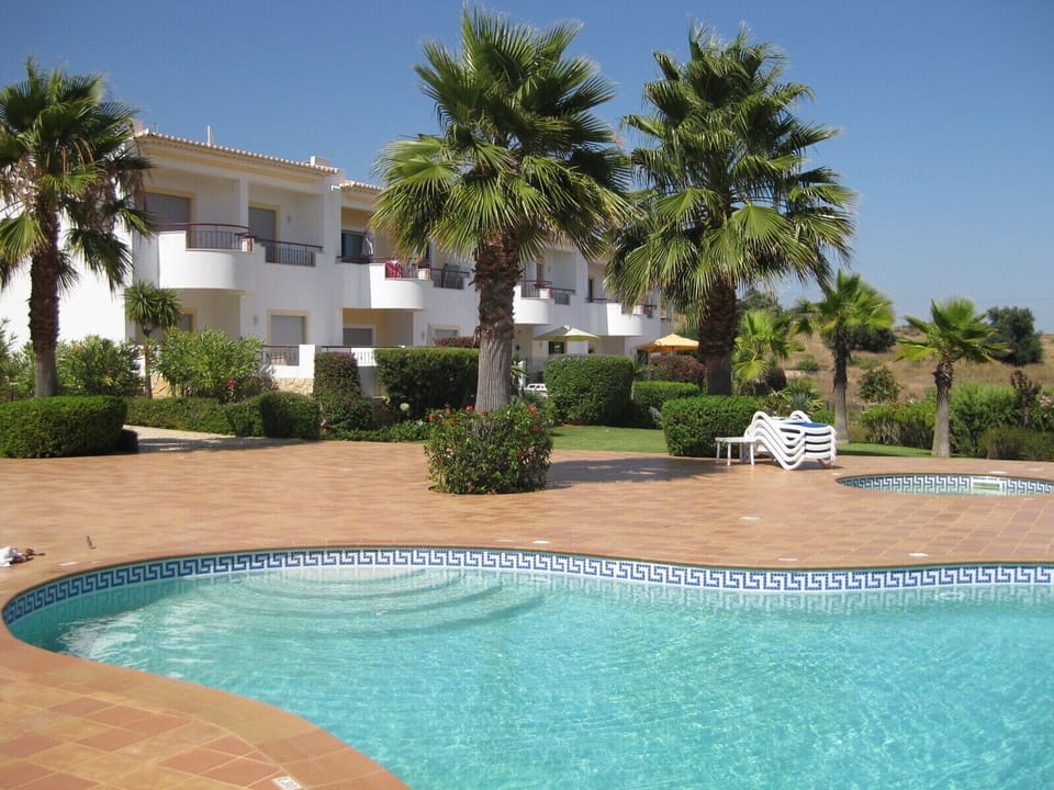 1 OF ONLY 4 APTS WITH DIRECT ACCESS VIA A LOCKABLE GATE TO THE GARDEN AND POOL  