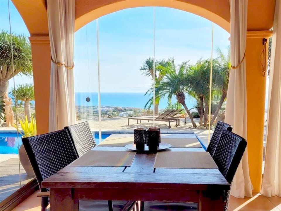 Dining area on the covered terrace with space for four guests with sea views