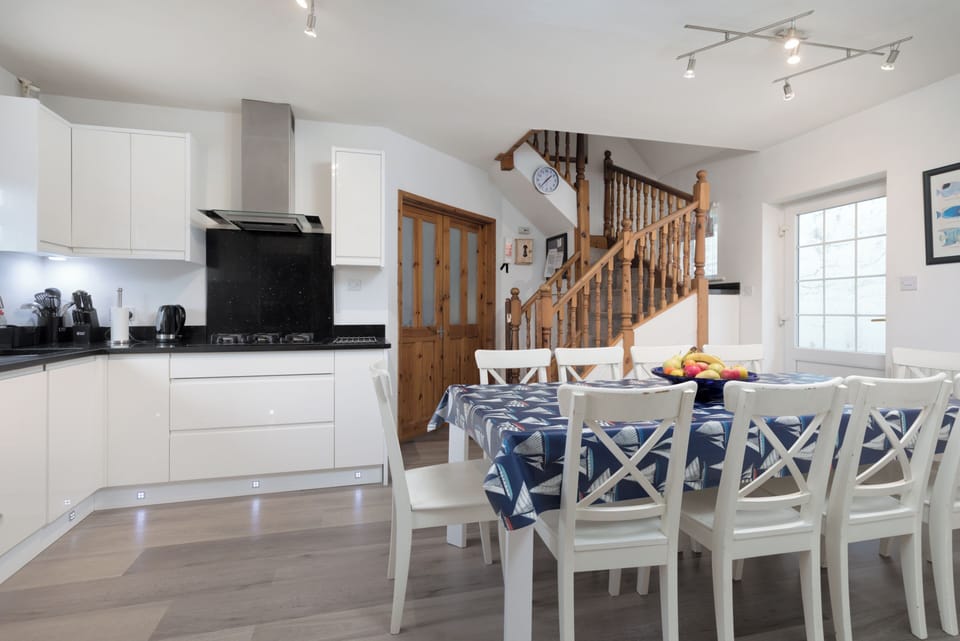 Dining area with table and chairs for 10.  Staircase leads to twin with ensuite.