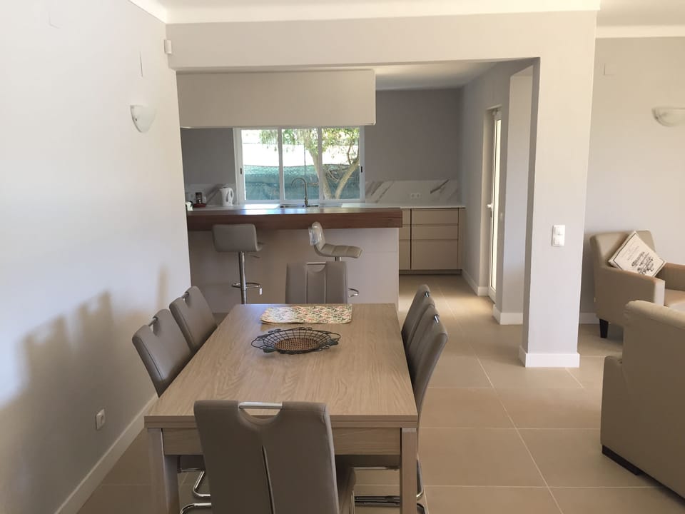 The dining table adjacent to the open plan kitchen. 