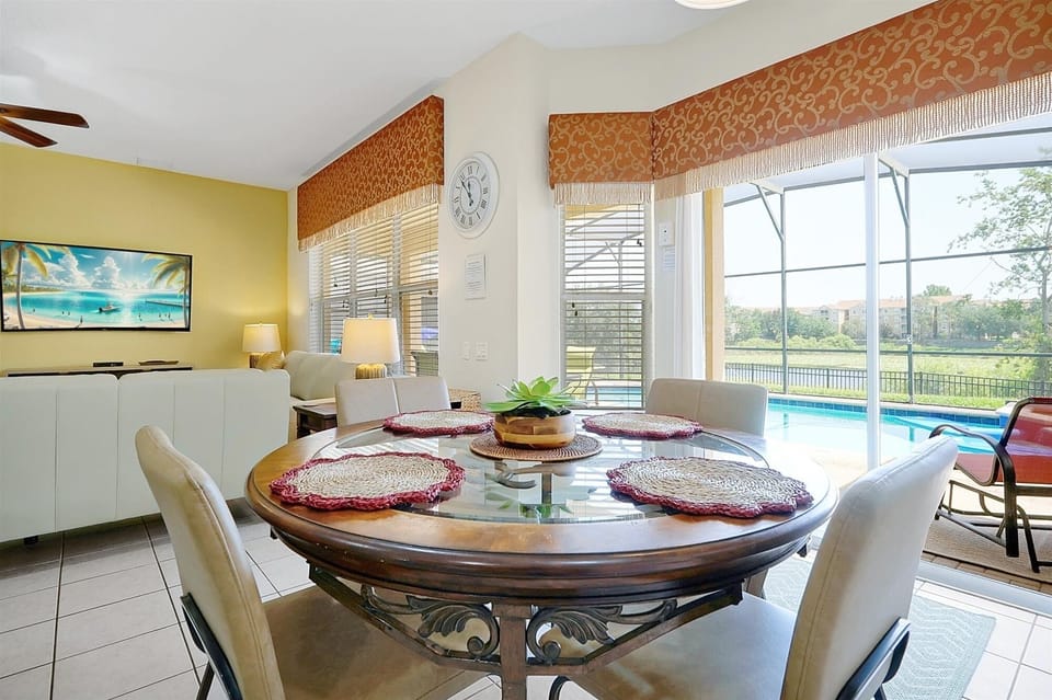 The bright informal kitchen dining area together with bar stools at the island