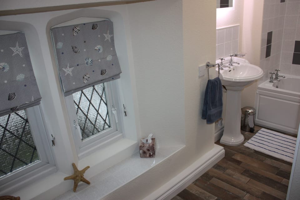 Large bathroom showing window area and illuminated mirror with shaving point
