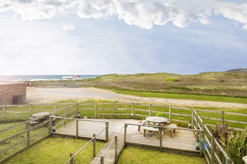Garden and wooden deck with sea views at Llawnroc Widemouth Bay