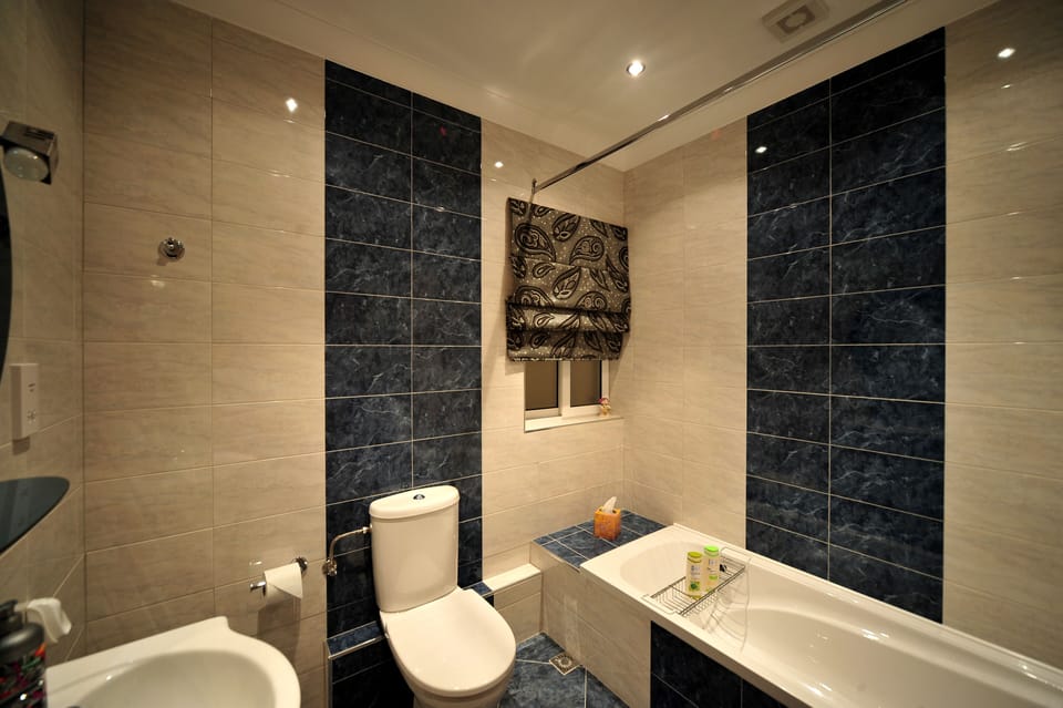 Main bathroom with bath/shower, wash hand basin and toilet