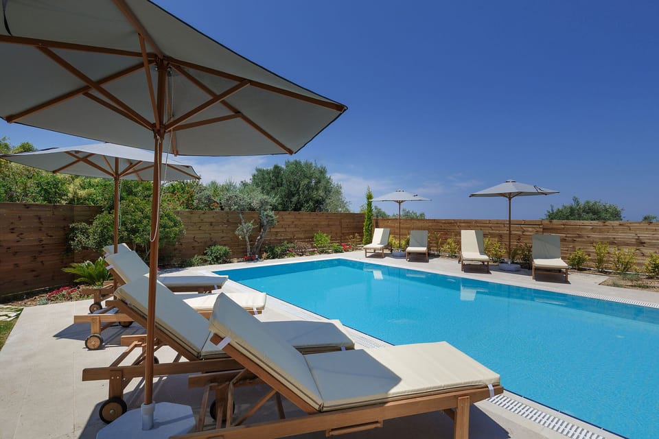 45 sq. m swimming pool, surrounded by sun beds & umbrellas