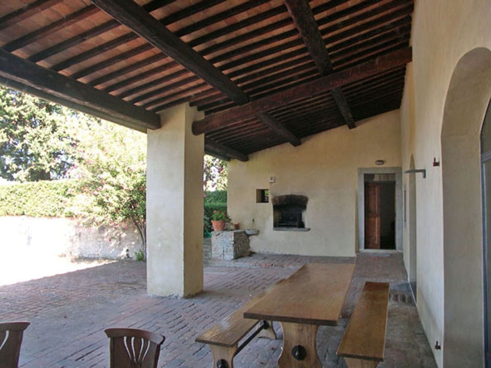 View of Loggia with dining table and bar-b-que (old bread oven)