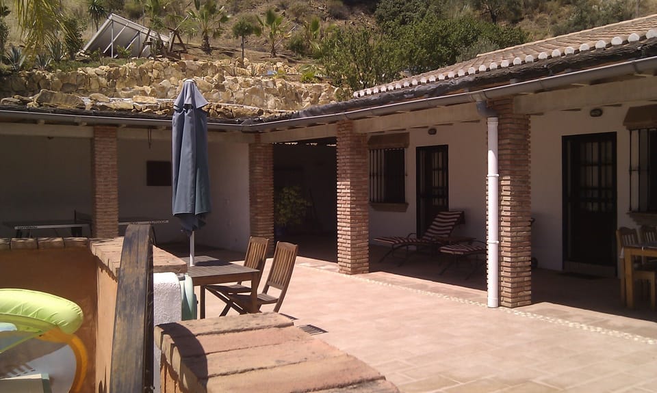 far end of the long terrace with recliners and 2 bedroom doors.