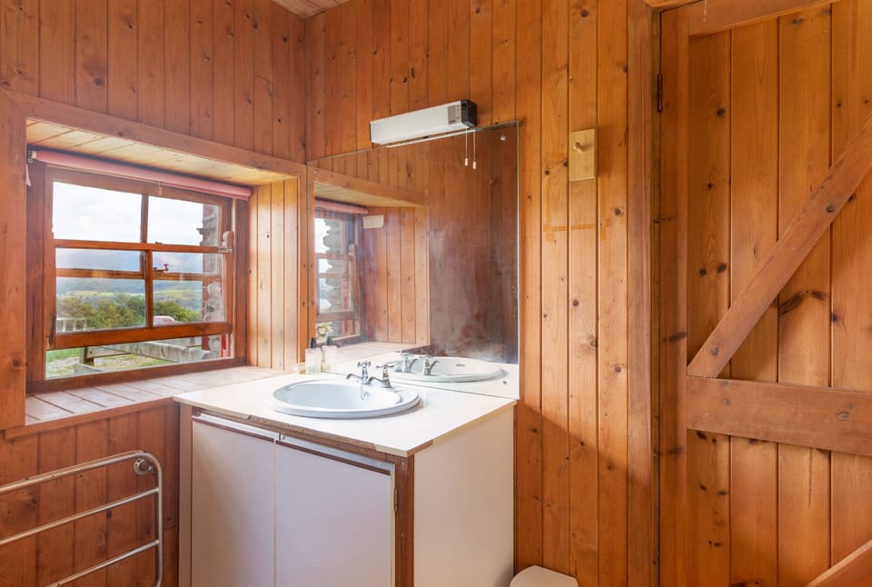 Lake cottage bathroom has superb view