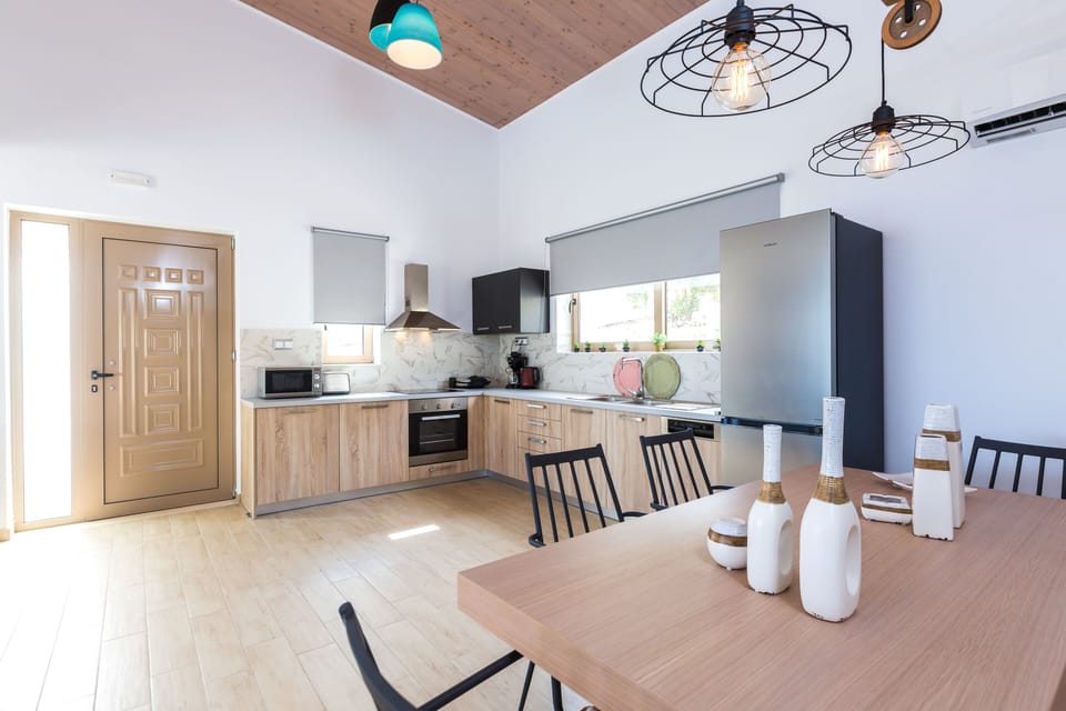 There is also a spacious dining area, featuring a modern wooden table with eight