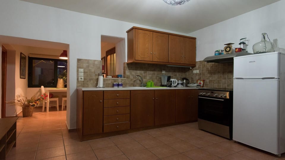 Fully equipped kitchen with separate dining area.