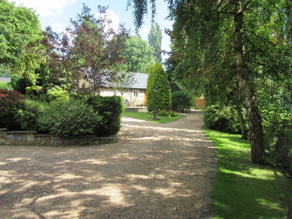 View from the front gate of The Wharf, with Wharf Stables in the distance.