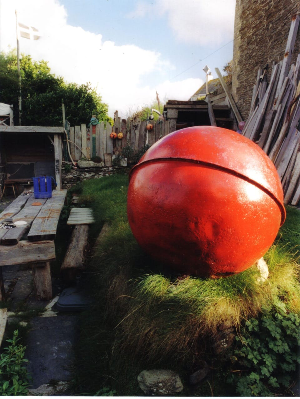 The American red buoy and driftwood  in the house garden.