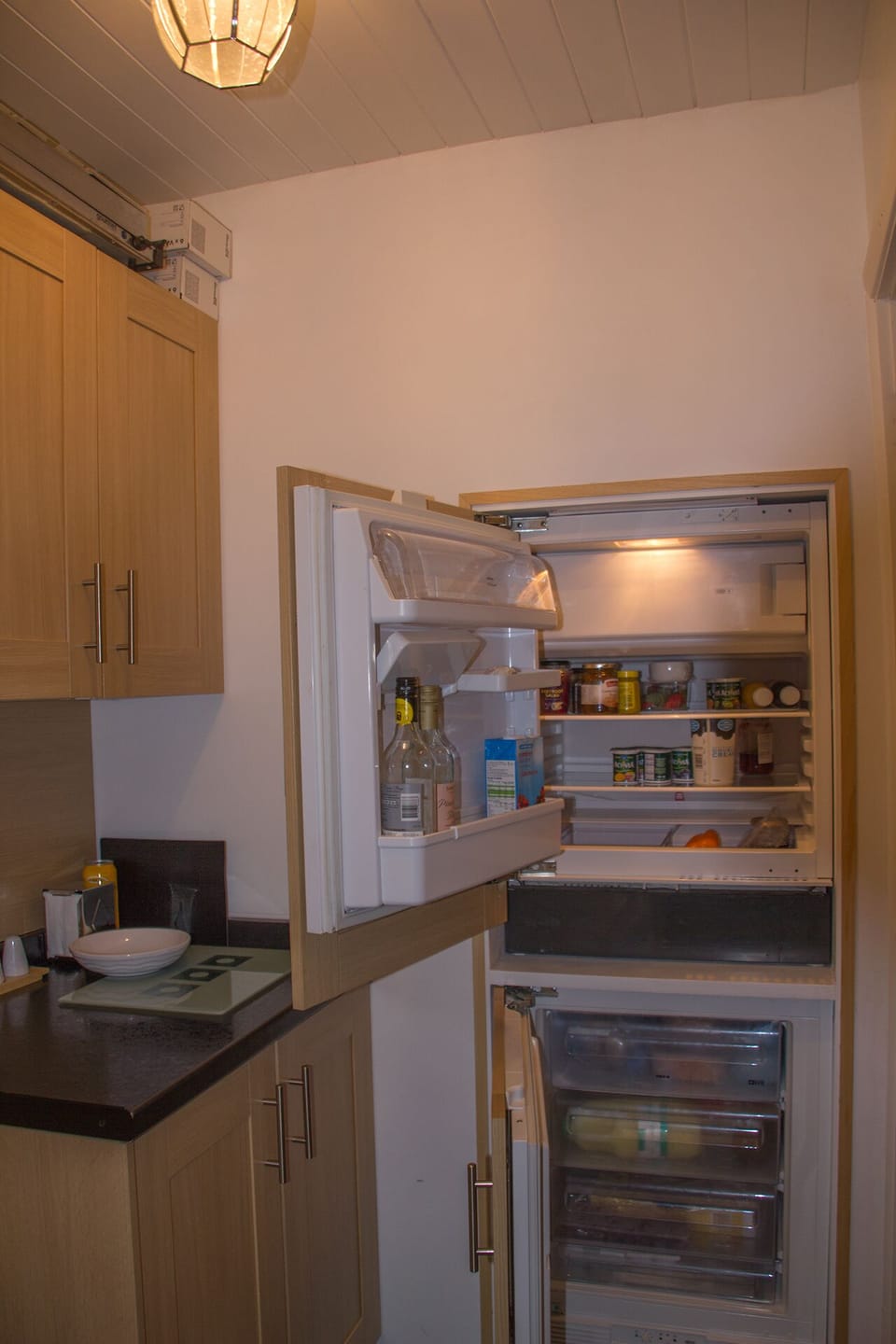 kitchen showing fridge and freezer. Also has dishwasher and washing machine