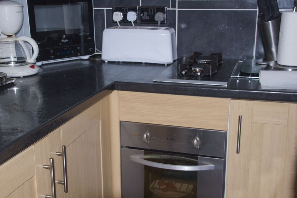 Kitchen area showing oven (450mm), two ring gas hob, microwave etc